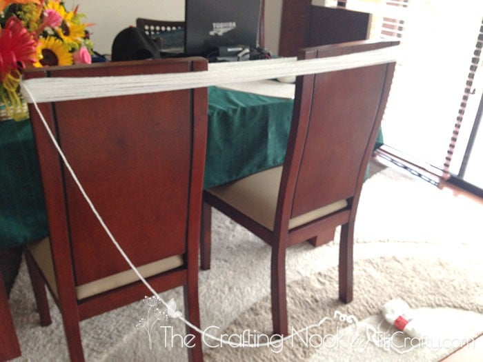 using the back of two chairs to measure wool yarn