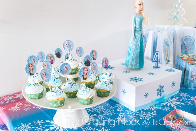 side view of decorated table with cupcakes and cake box Frozen Themed Birthday Party 