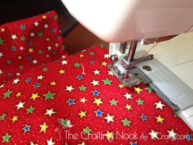 Stitching on the right side of the pillow case along the edges to create the fresh seam.