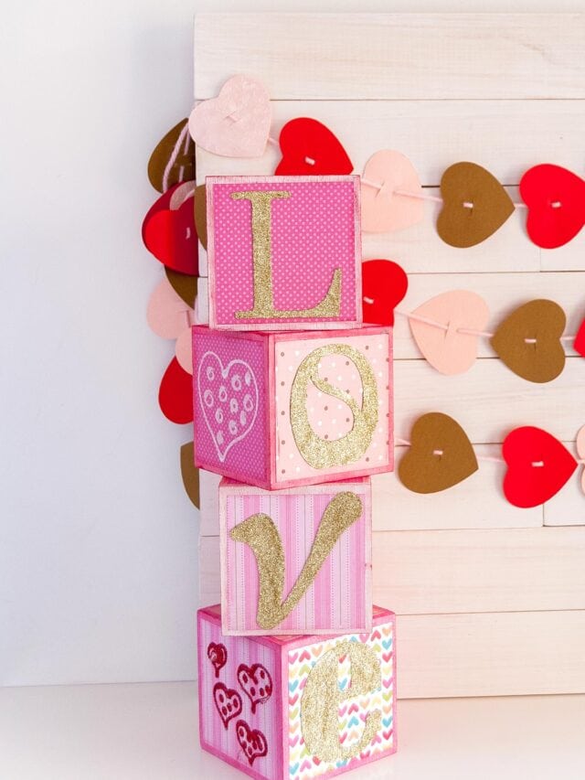 DIY Love Wood Letter Blocks for Valentine’s Day in different pink shades and gold letters. Feature image