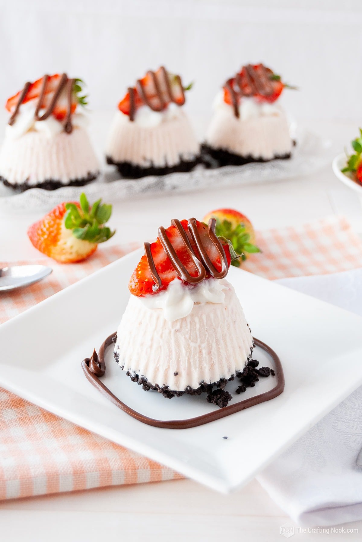 45 degree angle shot of one Individual Frozen Oreo Strawberry Pie in front and 3 behind