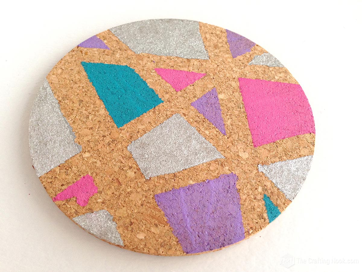 closeup of geometric painted cork coasters done