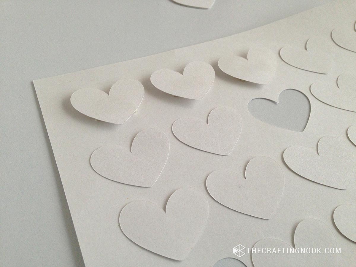 placing the cut hearts on the cardboard