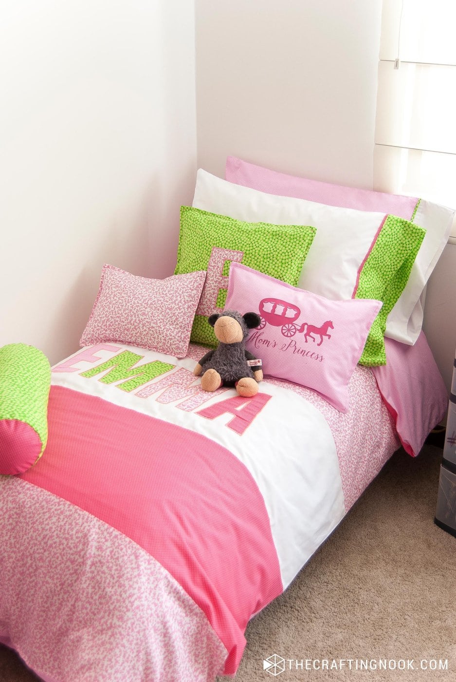 perspective view of the kid's bed wearing the Duvet Cover, handmade pillowcases and throw pillows.