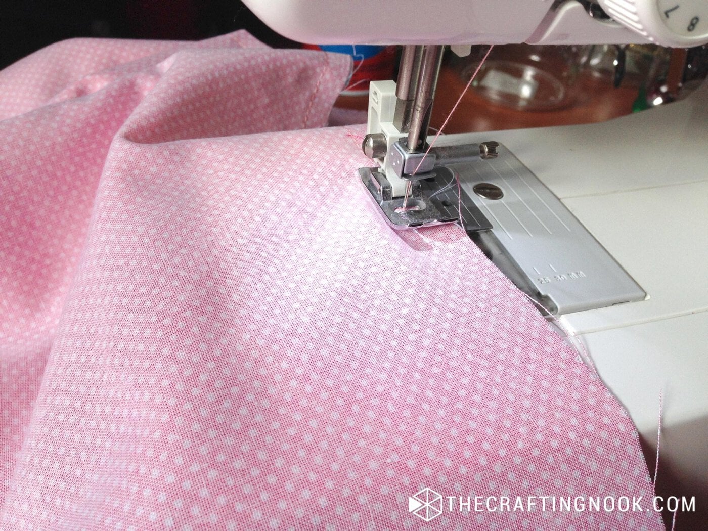 close up view of machine sewing on edge of fabric
