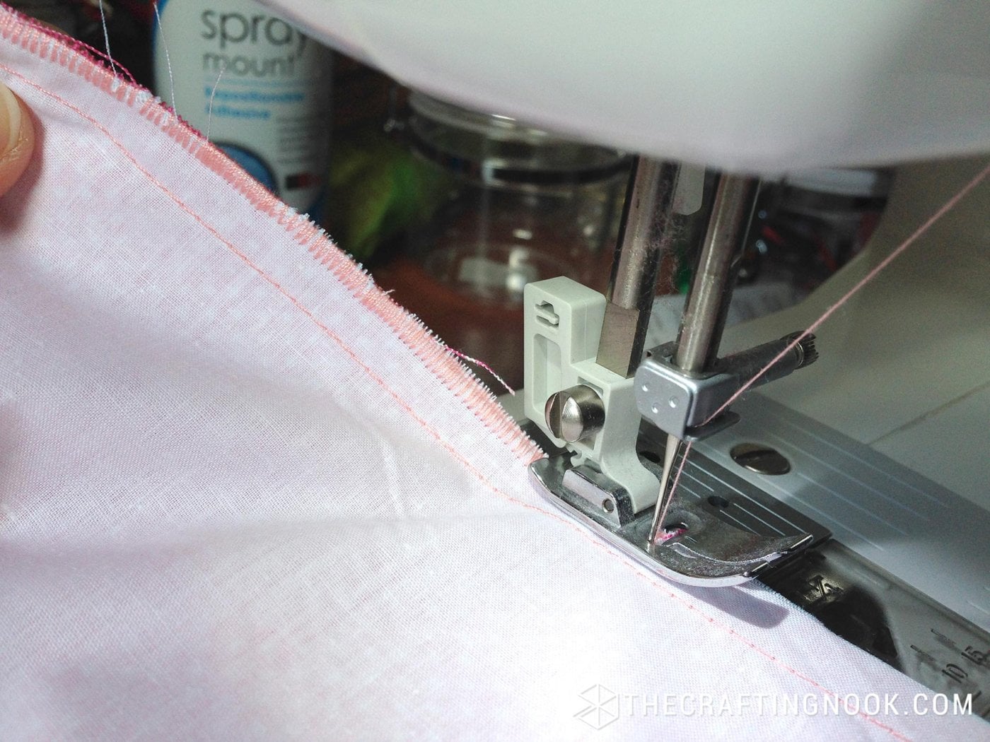 close up view of zigzag machine stitching on edge of fabric
