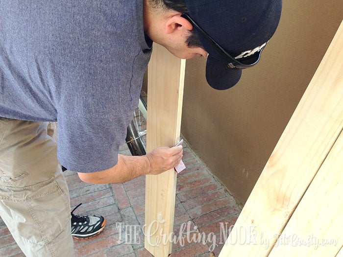 men sanding a piece of wood