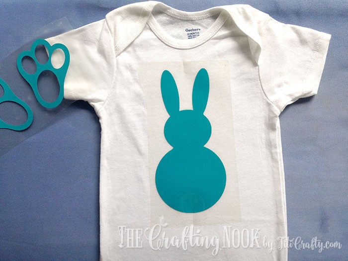 putting the htv bunny silhouette on the onesie