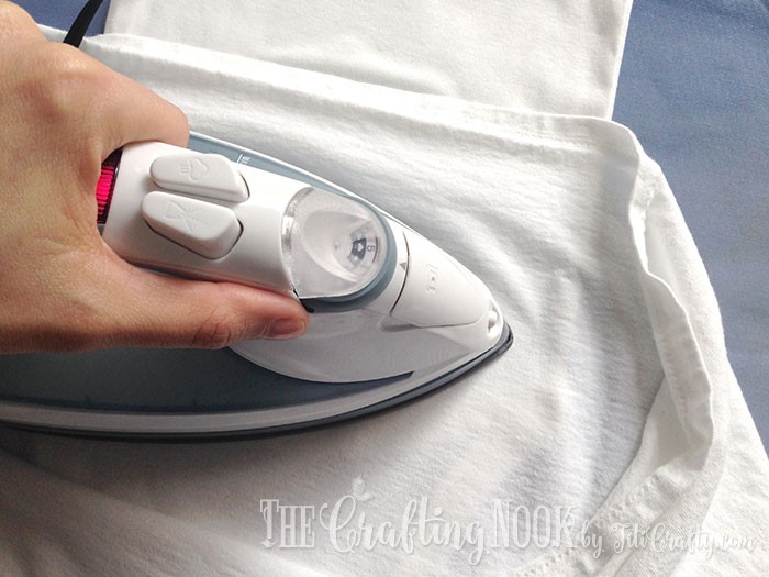 ironing the heat transfer on top of the fabric