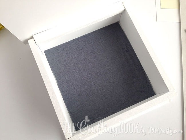 view of the gray felt cloth glued inside the wooden box