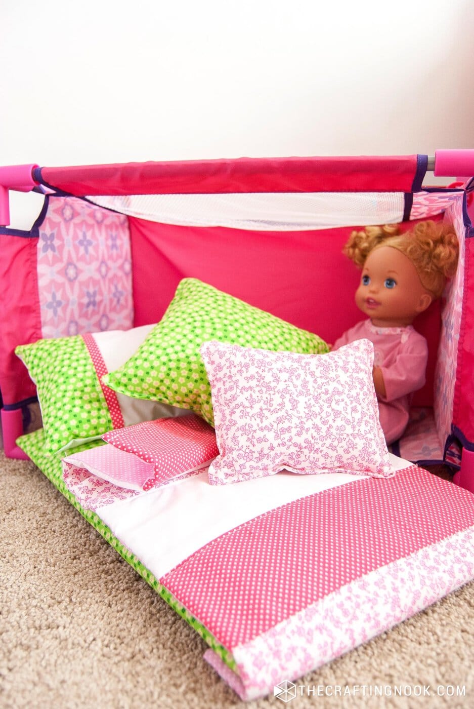 How to Make Doll Bedding Set for Cribs or Cradles. Feature Image. The bedding set on the floor next to the doll crib and a baby doll