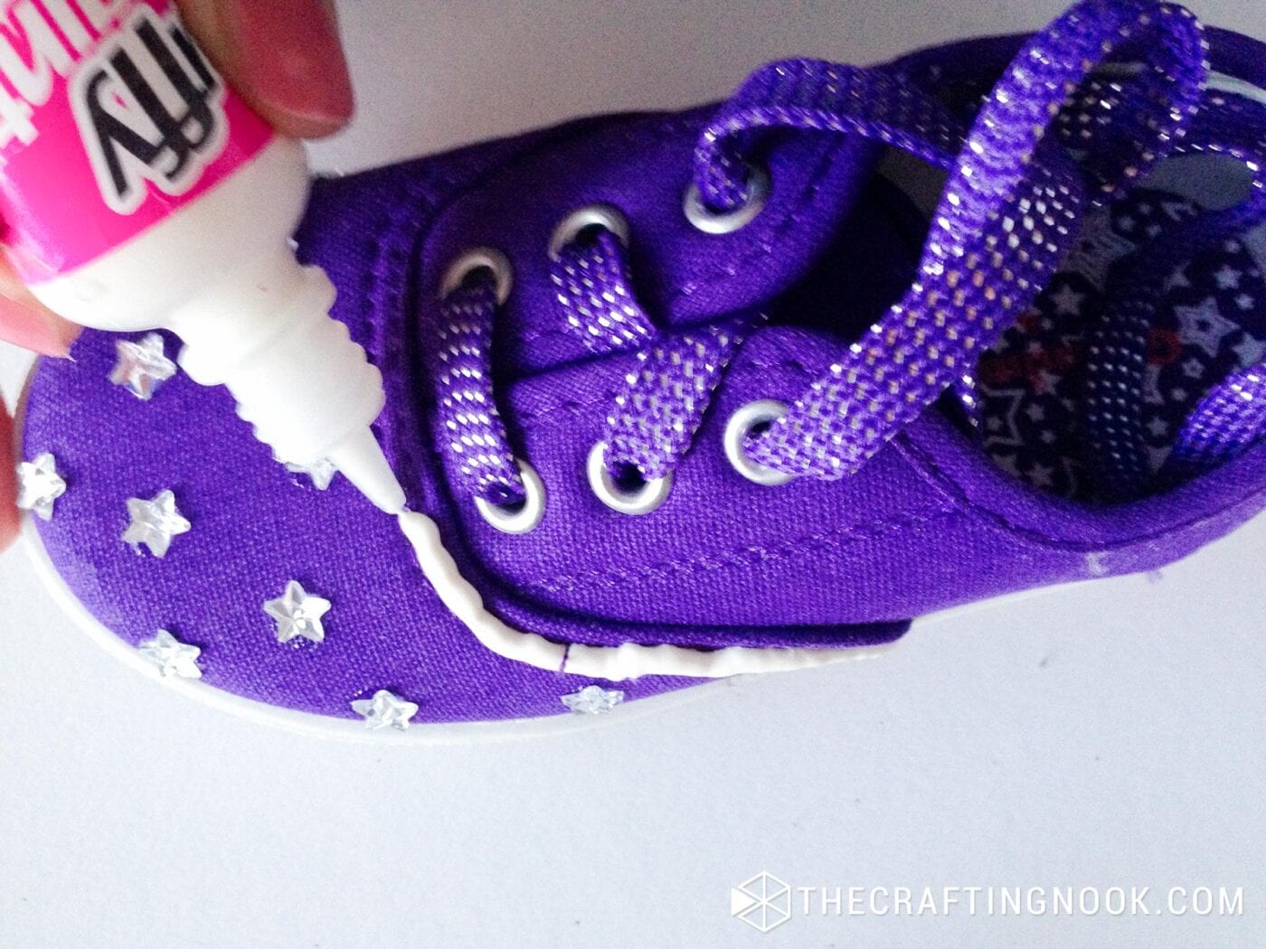 top view of Applying puffy paint over the center seam of the sneaker