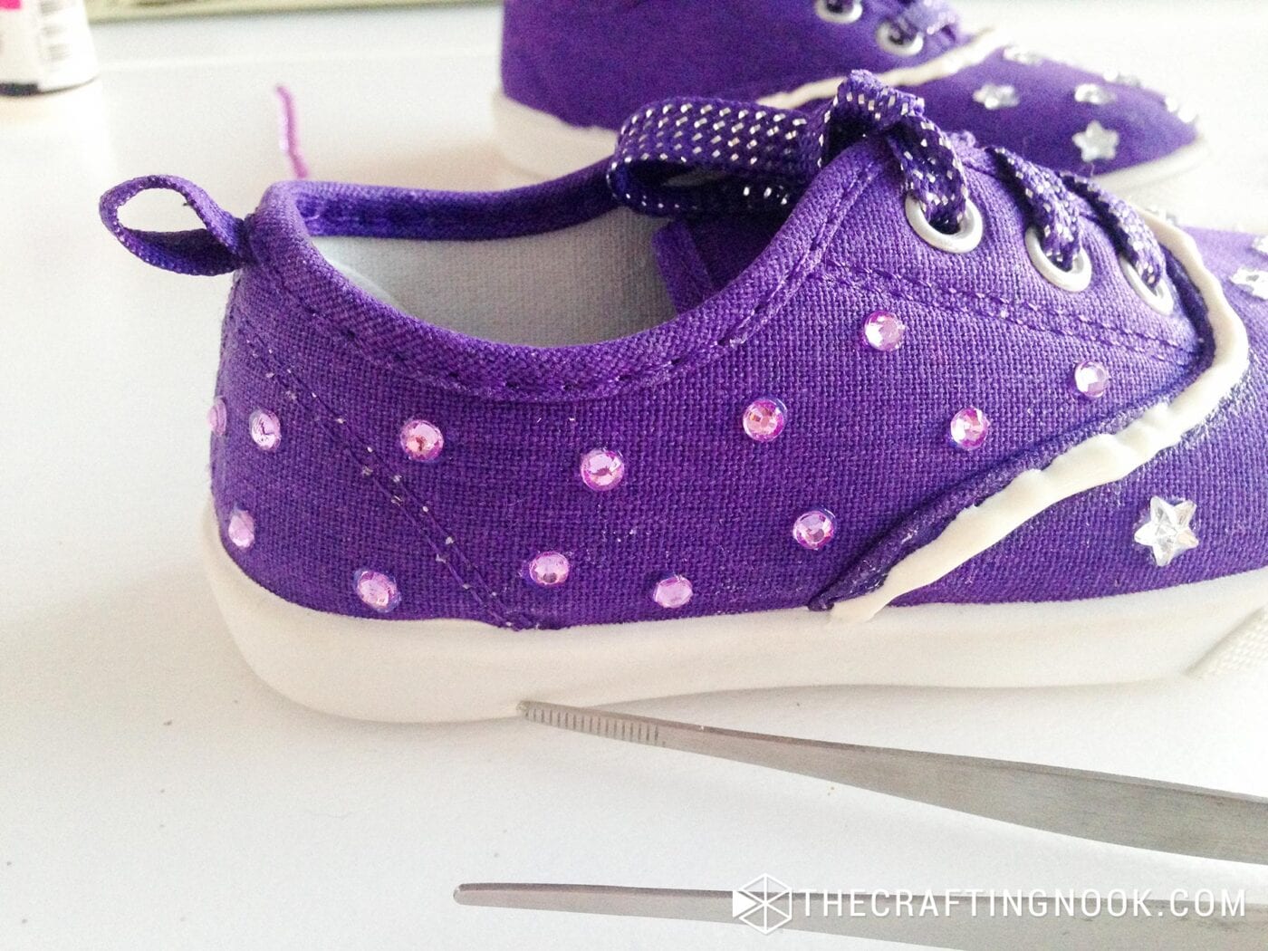 placing rhinestones on the other side of the shoe following the same process with the glue