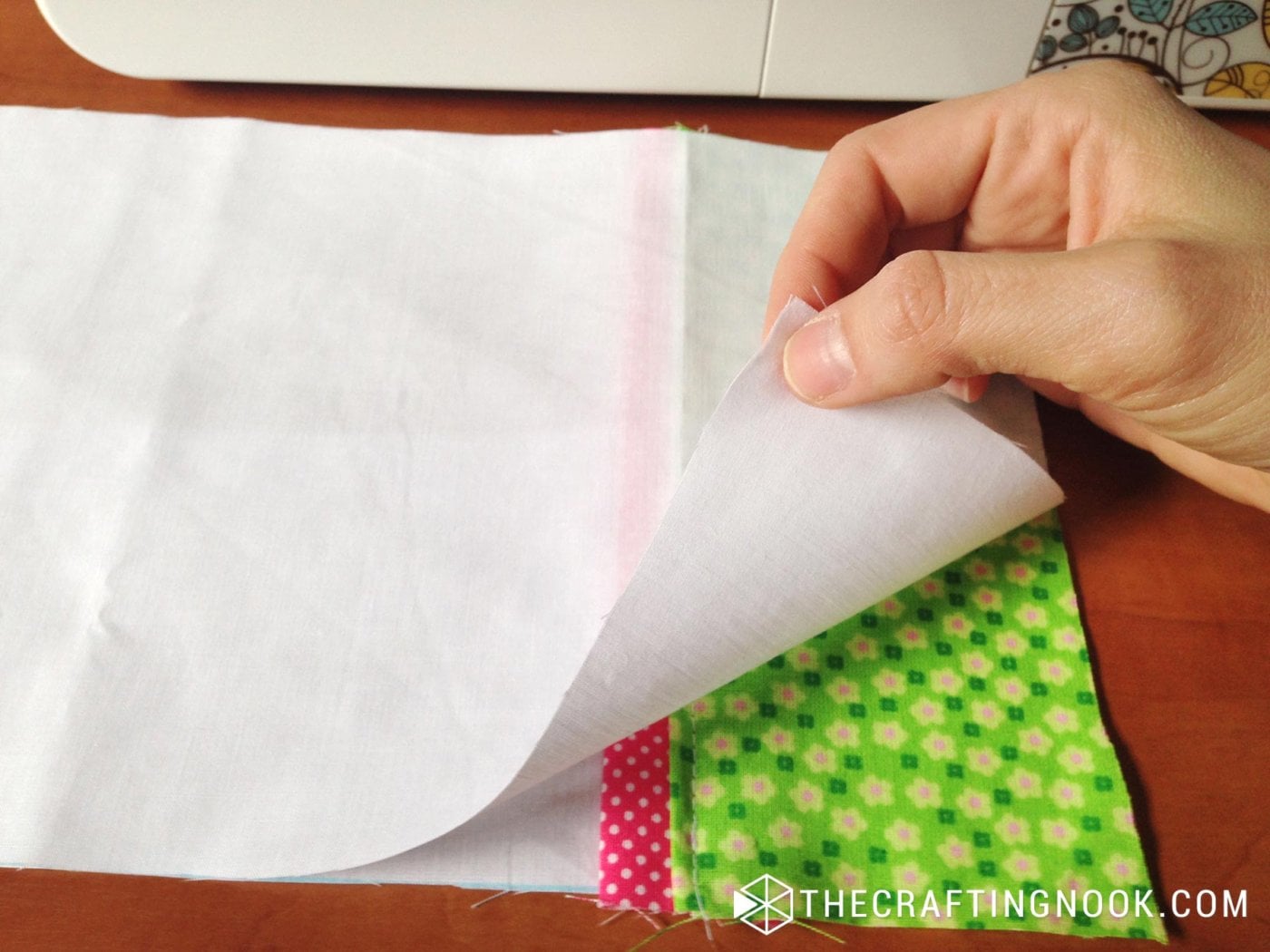 placing a piece of fabric over the sewn pieces