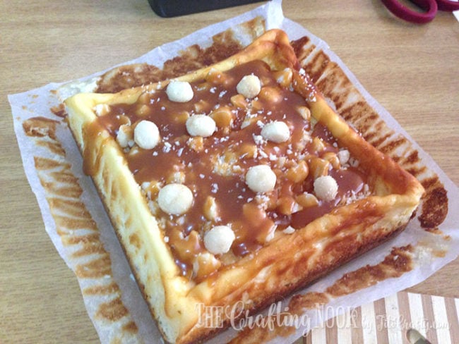 view of the cheesecake with larger pieces of macadamia to finish the recipe