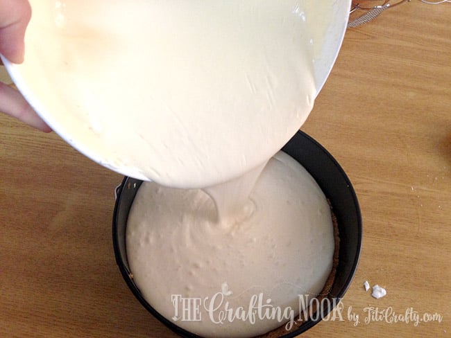 pouring the cheesecake mixture into the pan