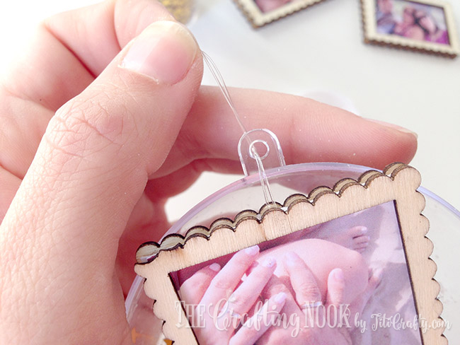 securing the mini frames on the inside of the ornament with nylon