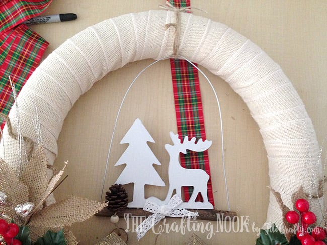 view of Adding final touches like ribbon and ornaments to the Burlap Christmas Wreath