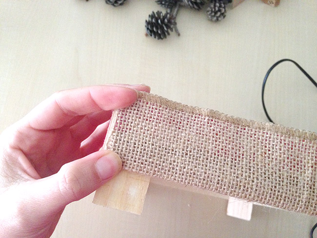 sticking the burlap ribbon on a fruit crate