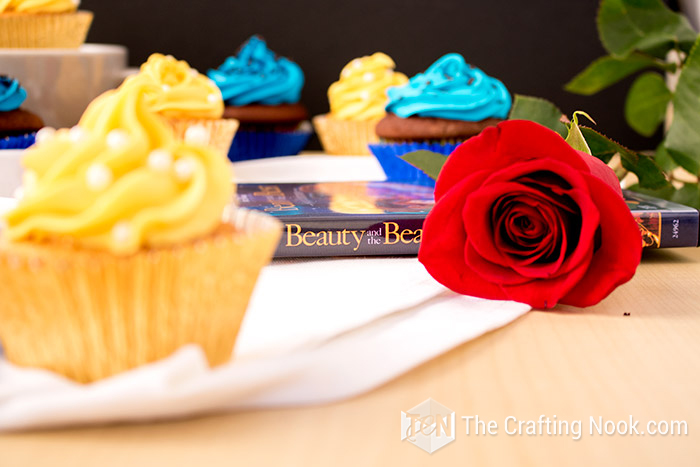 close view of the cupcake and the DVD of The Beauty and the Beast in the background