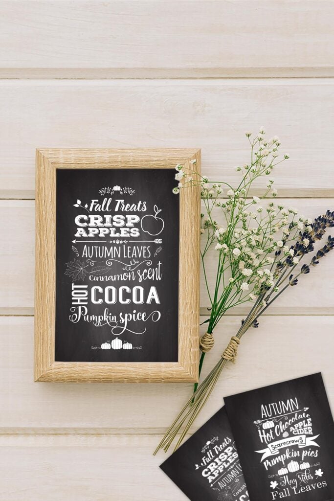 Fall Chalkboard Art Free Printablein a cute wooden frame on a table with some dried greenery