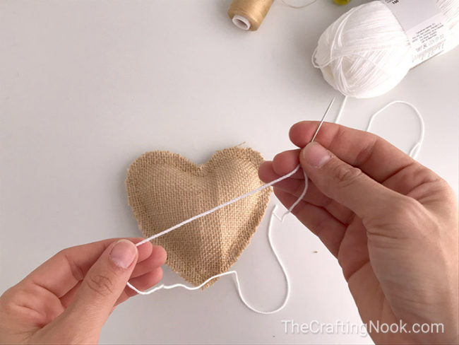 preparing a yarn needle and a white yarn