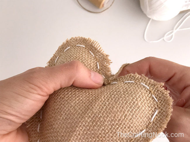 closer view of a string of twine stitching the shape (heart)