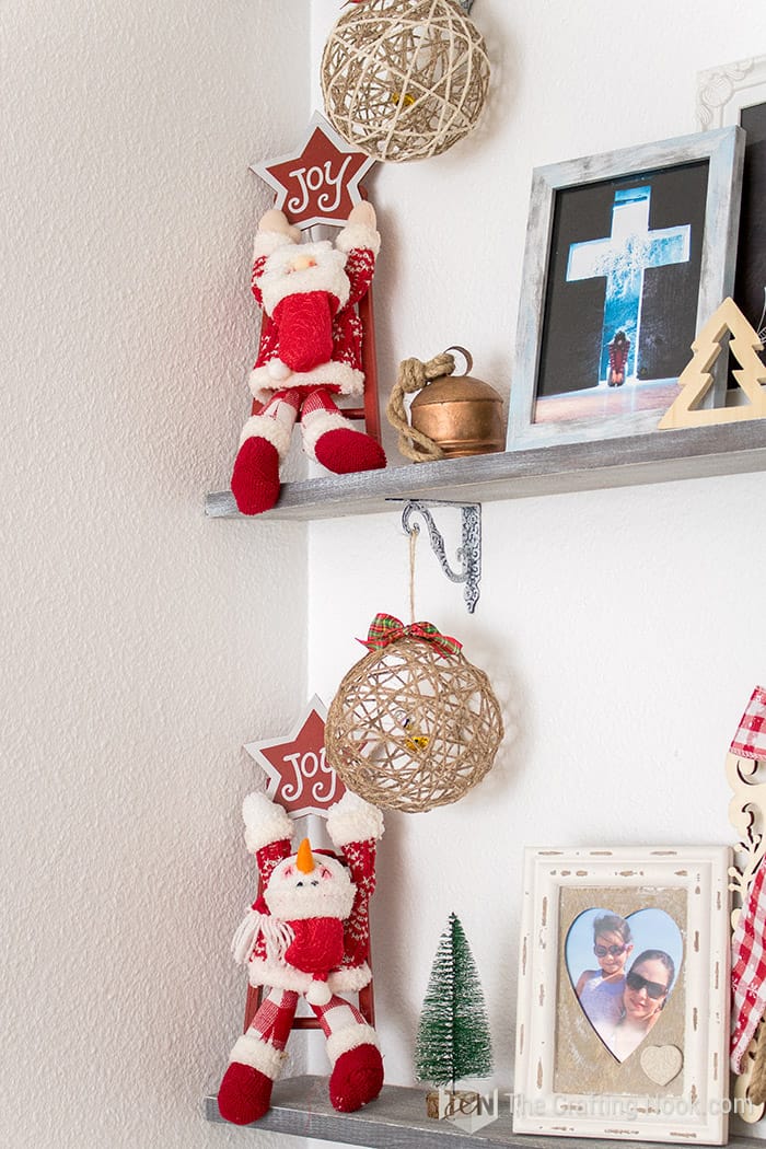 closer view of two fellas on the stairs  hung from the shelf brackets decorations.