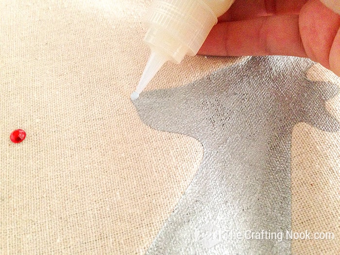 applying a dab of fabric glue