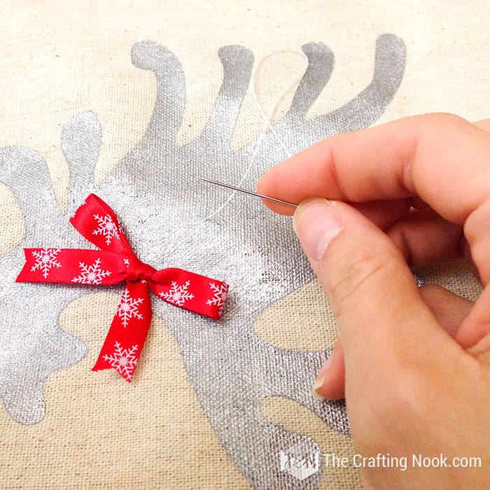 sewing the bow on silver reindeer