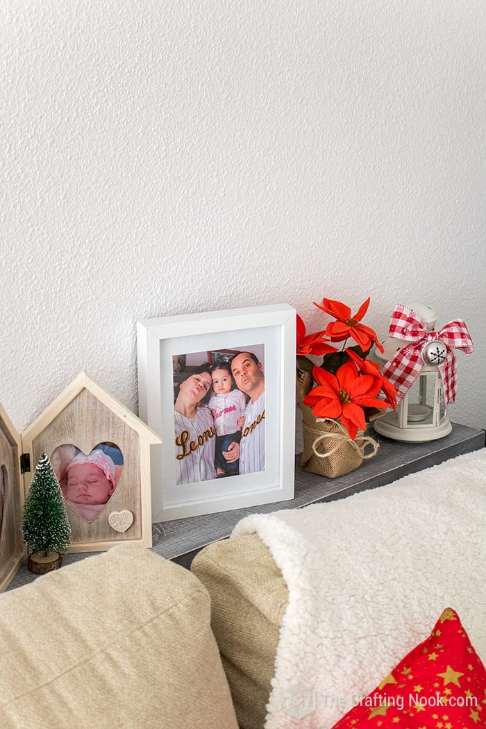 closer view of Behind the Sofa, some frames with meaningful photos