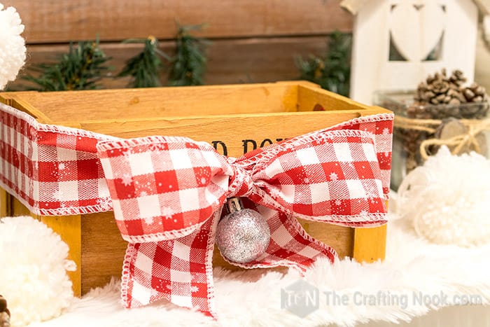 wooden key holder decorated with white-red plaid ribbon bow.