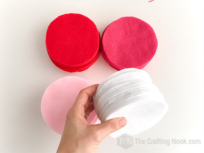 Red, dark pink, light pink and white felt cut in circles and pilled up.