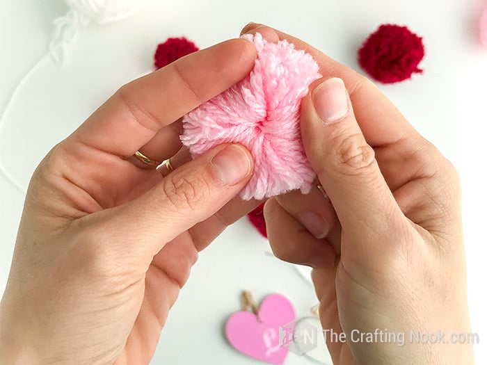 Showing the heart of the pom pom where all strings converge.