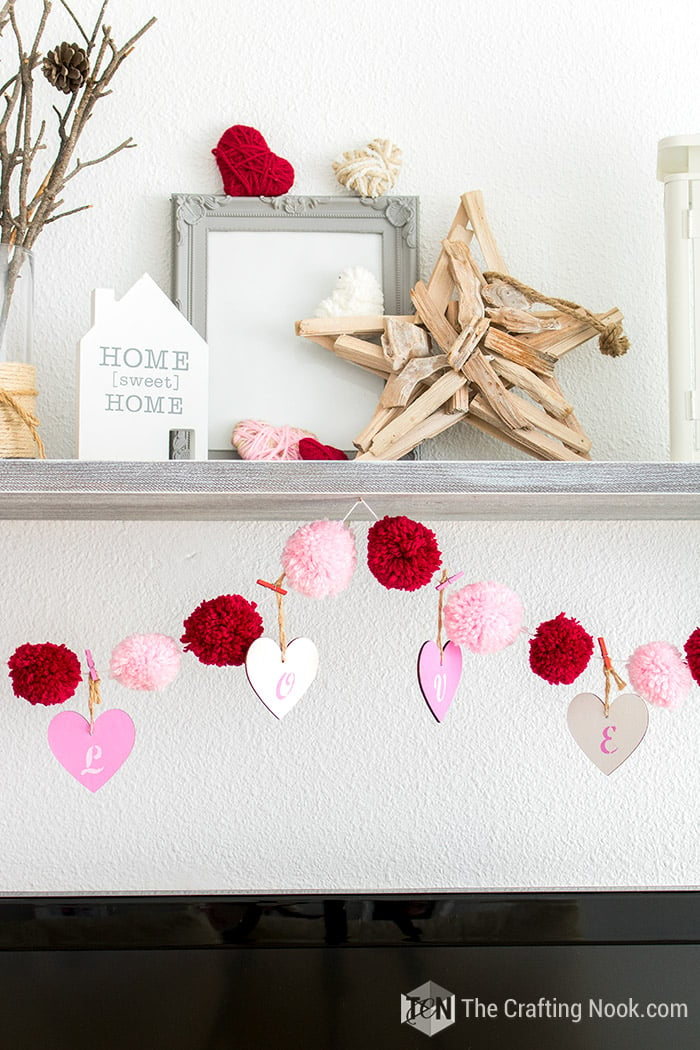 A closeup fo the Pom Pom Garland where it can read L O V E on the hearts