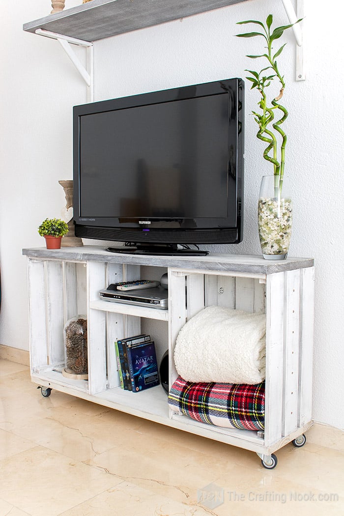 Rustic tv console table with the tv and some decor 