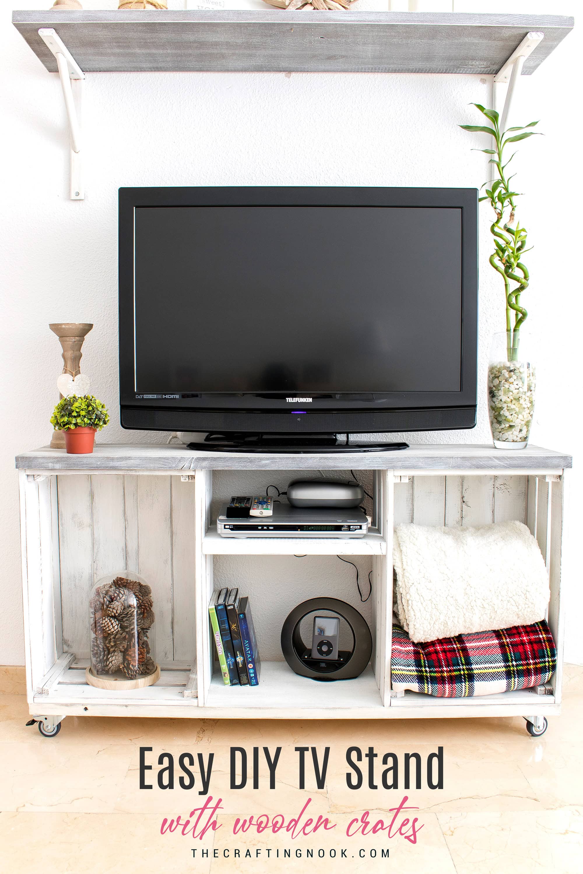 Front view of a farmhouse TV stand made from two distressed white wooden crates with open storage and a gray top.
