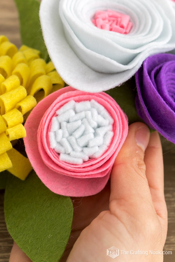 A super closeup view of the pink felt flower diy with white center