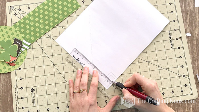 measuring and drawing the buckle on the back of the gold cardstock