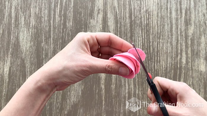 cutting the excess felt form the bottom of the felt flower