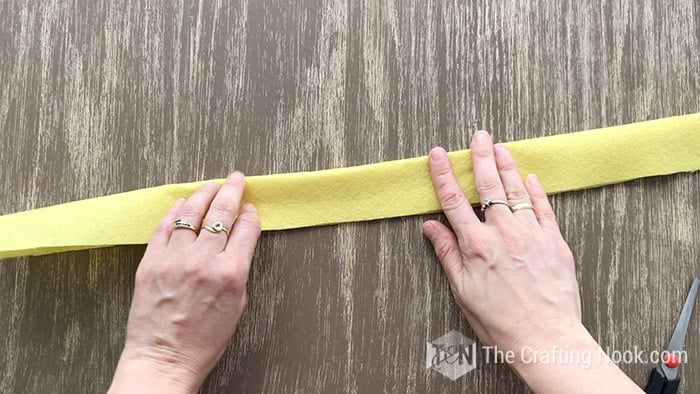 Folding the yellow felt in half lengthwise