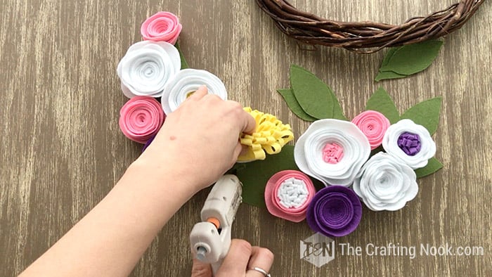 Gluing the yellow felt flower