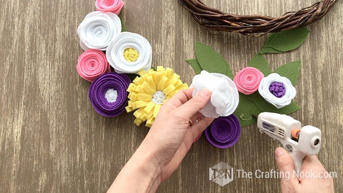 Gluing the white felt flowers