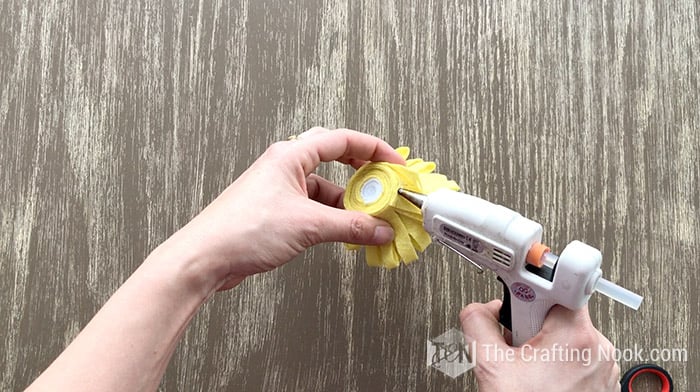 hot gluing the end of the yellow felt