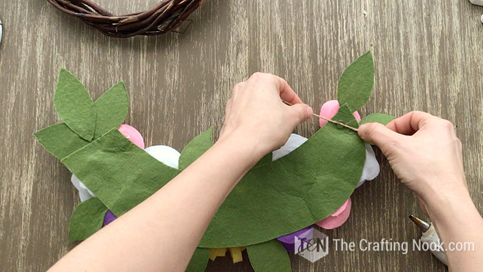 Gluing the twine with hot glue to the back of the bouquet