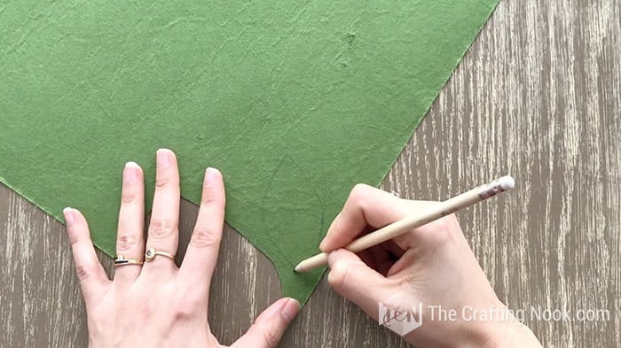 drawing a leaf shape on green felt