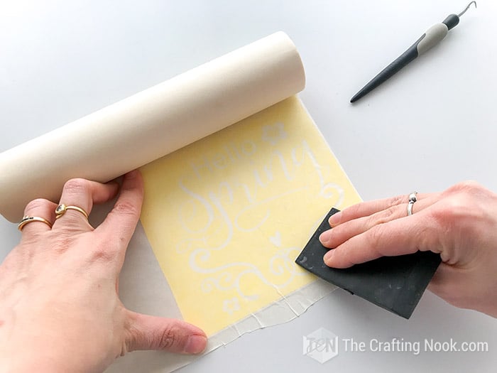 applying your transfer paper onto the vinyl