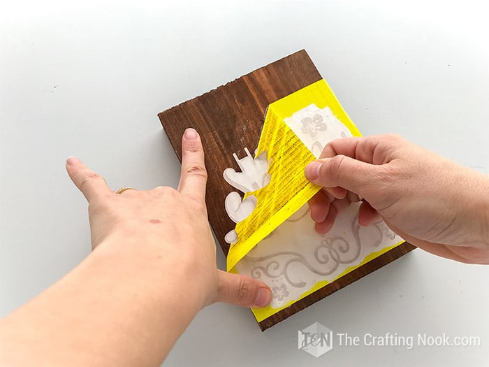 removing carefully the vinyl from the wood piece