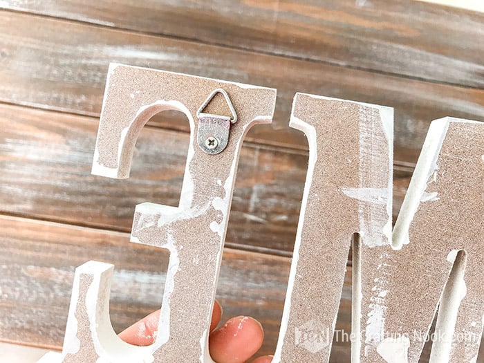 showing the hangers on the back of the wooden letters