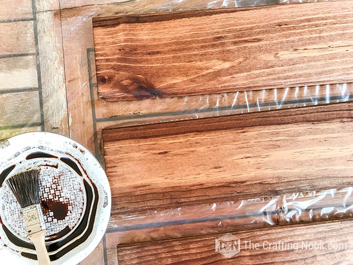 Staining the shiplap boards with walnut stain.